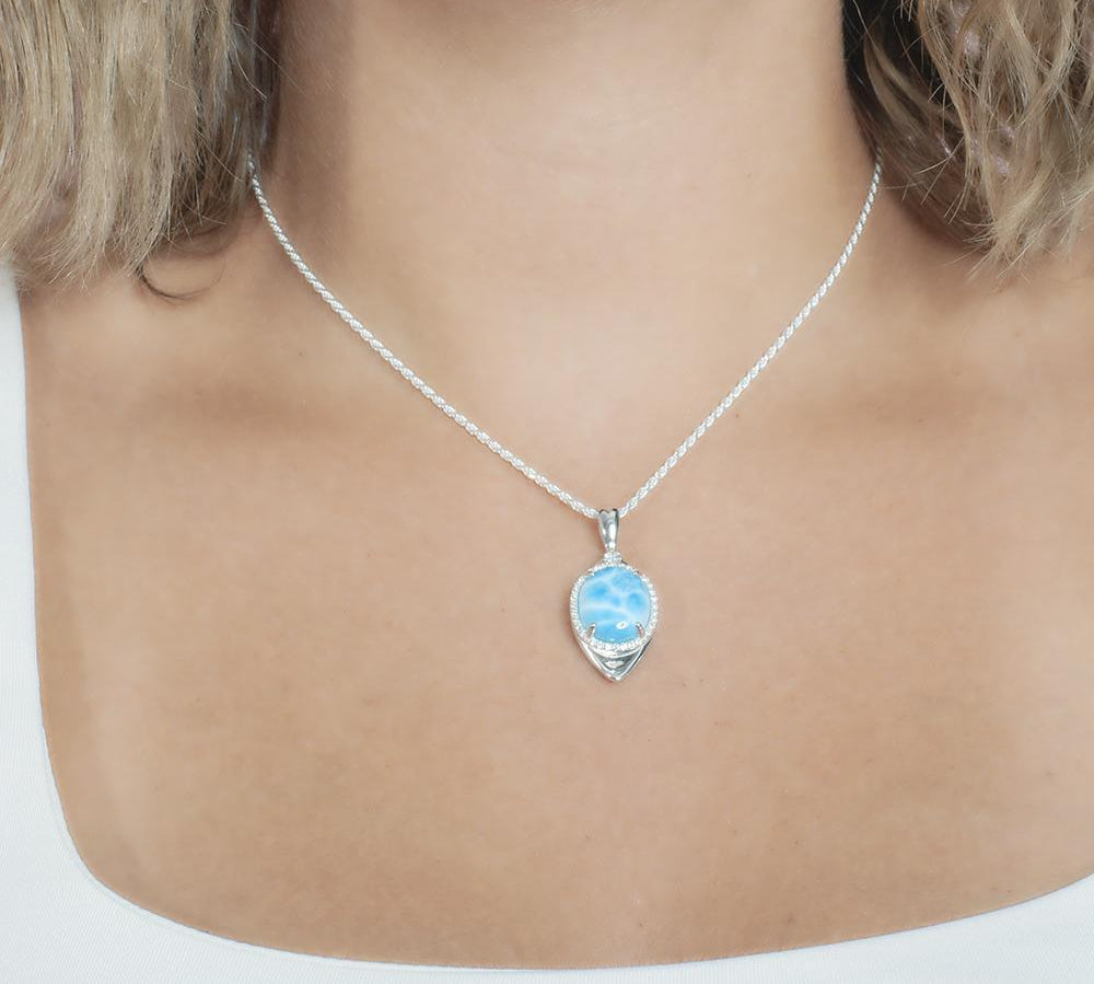 The picture shows a model wearing a 925 sterling silver larimar eye of the storm pendant.