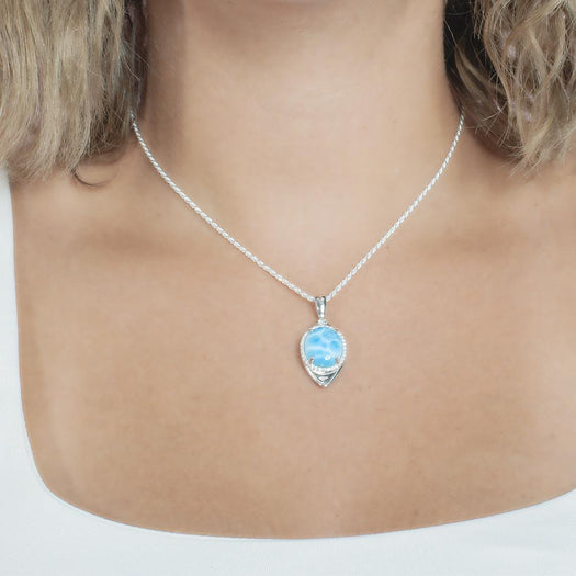 The picture shows a model wearing a 925 sterling silver larimar eye of the storm pendant.