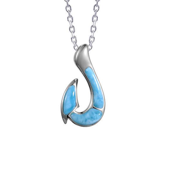 In this photo there is a sterling silver fish hook pendant with blue larimar gemstones.