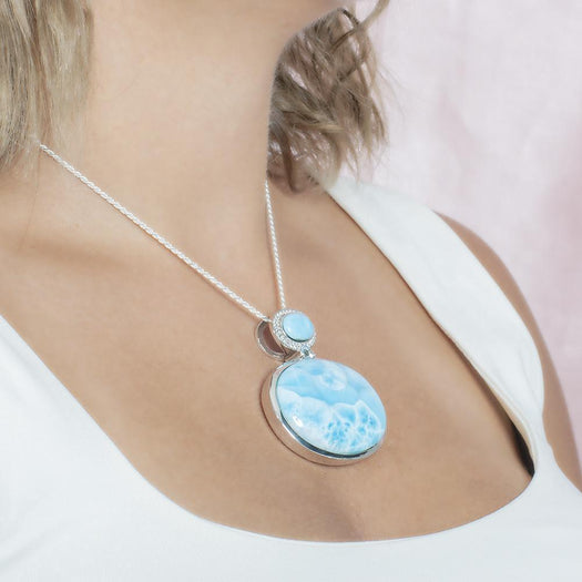 The picture shows a model wearing a 925 sterling silver larimar pendant.