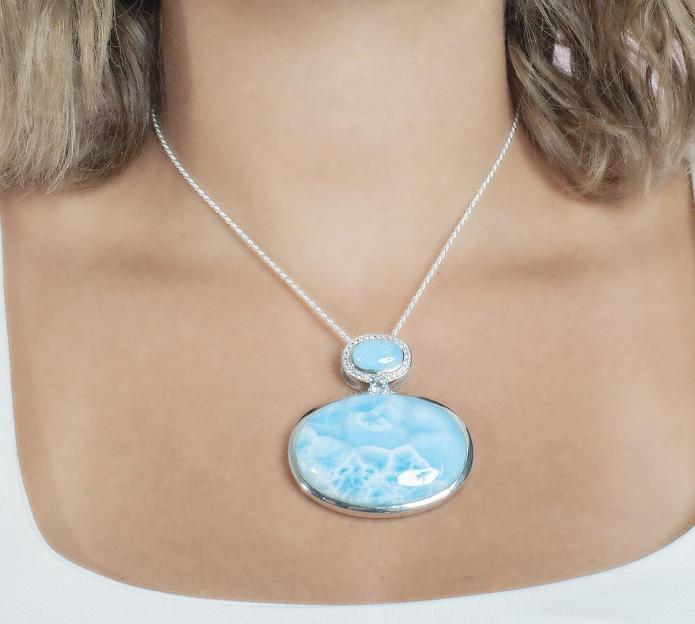 The picture shows a model wearing a 925 sterling silver larimar pendant.