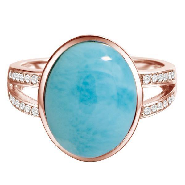 The picture shows a 14K rose gold larimar cocktail ring with a split band lined with diamonds and topaz gemstones