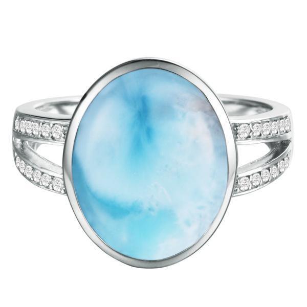 The picture shows a 14K white gold larimar cocktail ring with a split band lined with diamonds and topaz gemstones