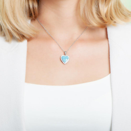 The picture shows a model wearing a 925 sterling silver larimar heart pendant.