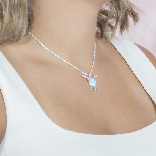 The picture shows a model wearing a 925 sterling silver larimar honu pendant.