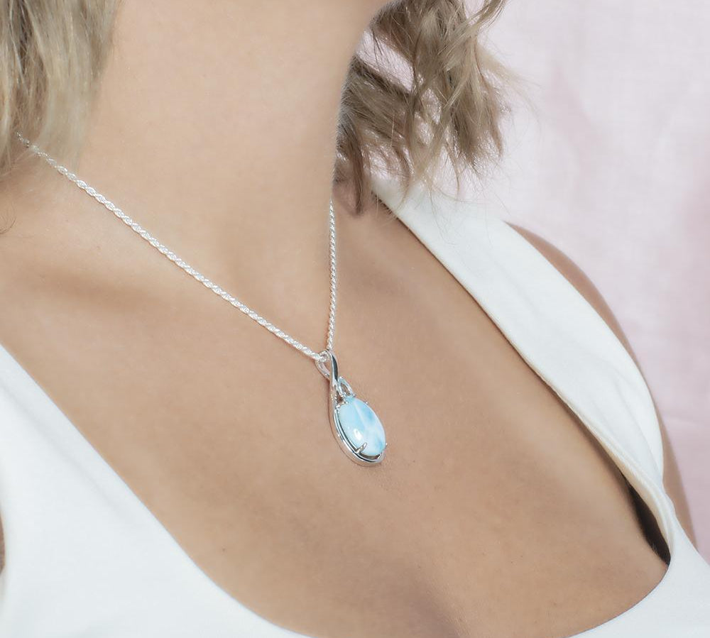 The picture shows a model wearing a 925 sterling silver larimar hidden gem pendant.