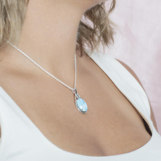 The picture shows a model wearing a 925 sterling silver larimar hidden gem pendant.