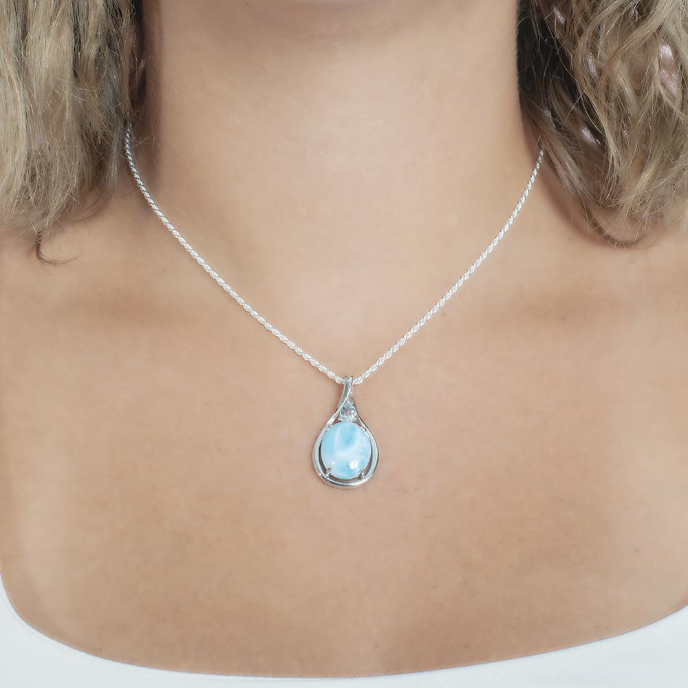 The picture shows a model wearing a 925 sterling silver larimar hidden gem pendant.