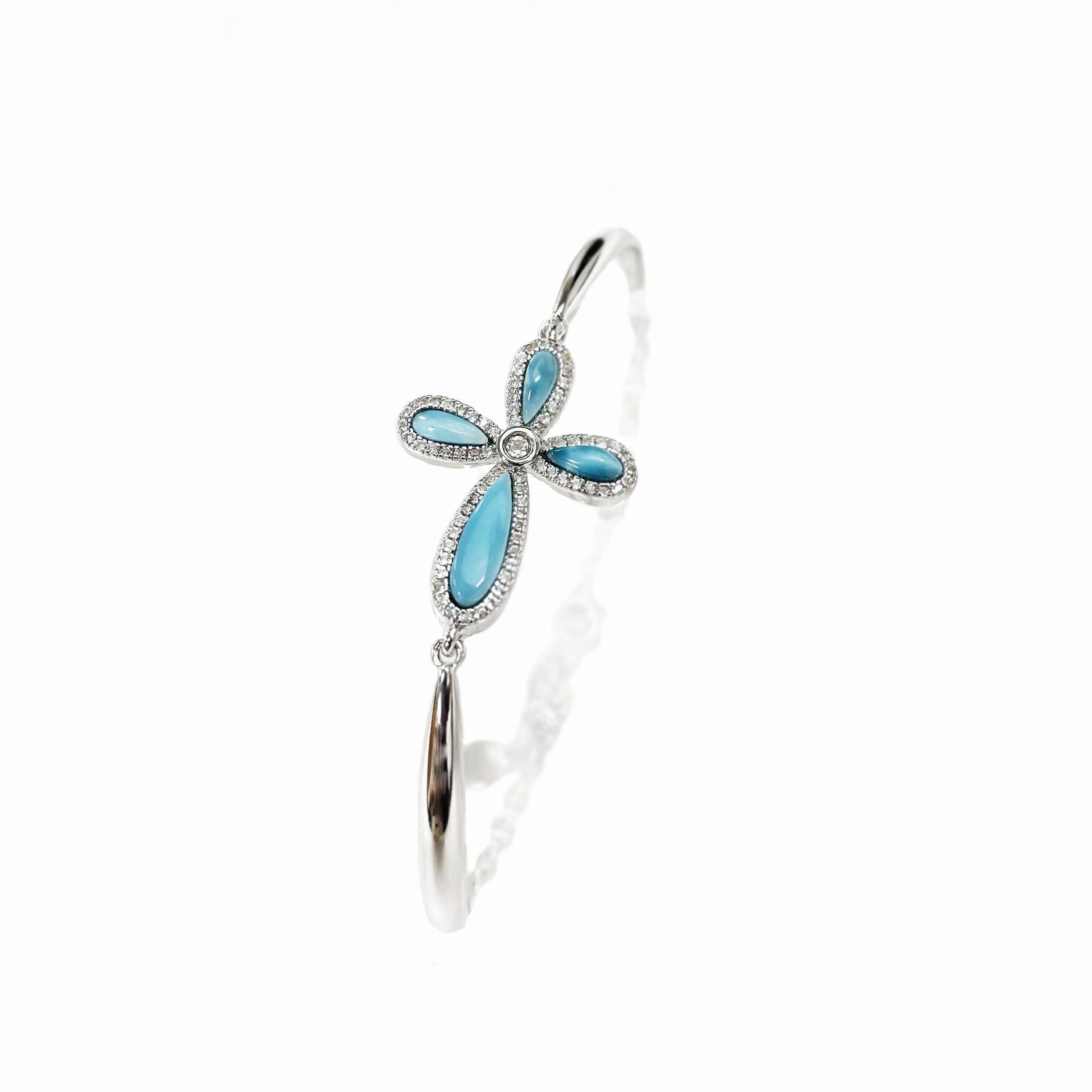 The picture shows a 925 sterling silver larimar cross bracelet and topaz.
