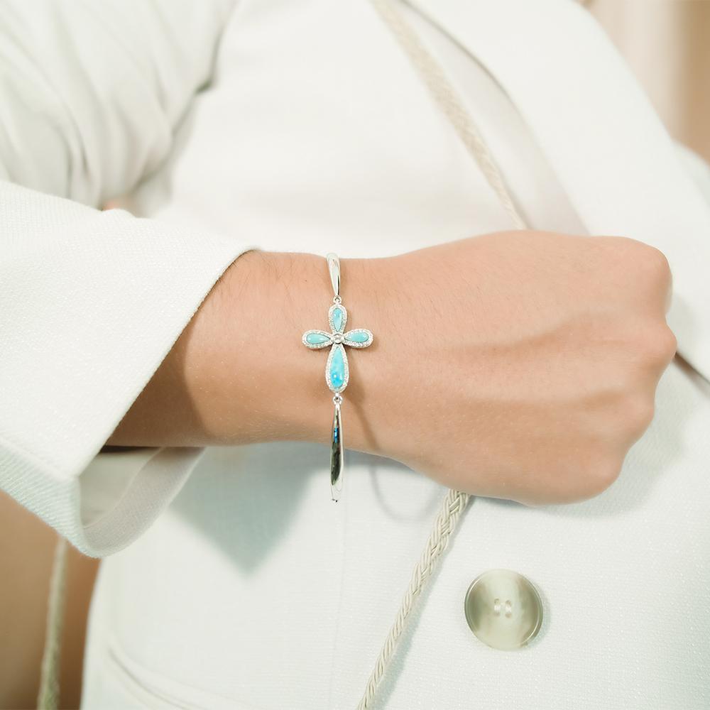 The picture shows a 925 sterling silver larimar cross bracelet and topaz.