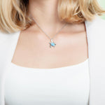 The picture shows a model wearing a 925 sterling silver larimar sea turtle pendant.