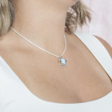 The picture shows a model wearing a 925 sterling silver larimar sea turtle pendant.