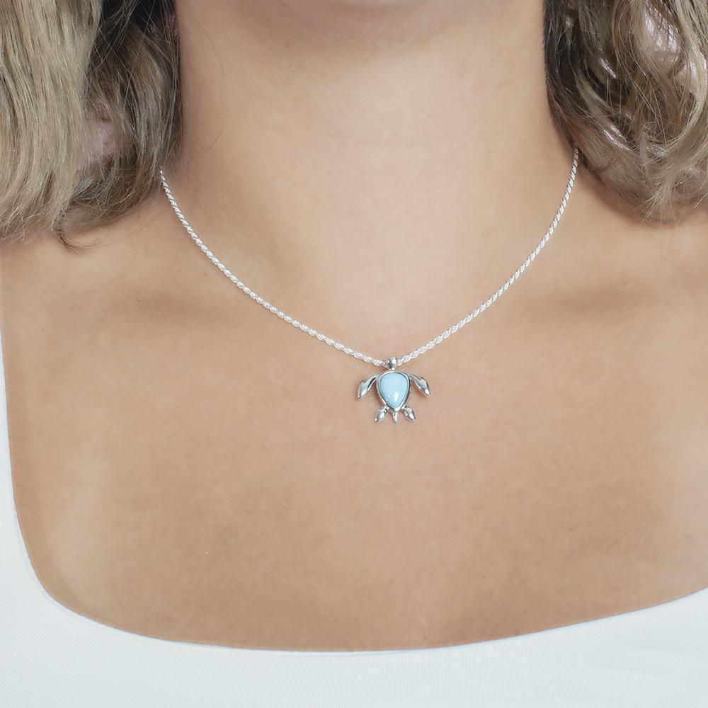 The picture shows a model wearing a 925 sterling silver larimar sea turtle pendant.