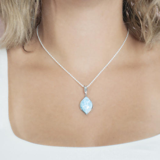 The picture shows a model wearing a 925 sterling silver larimar loa mandorla pendant.