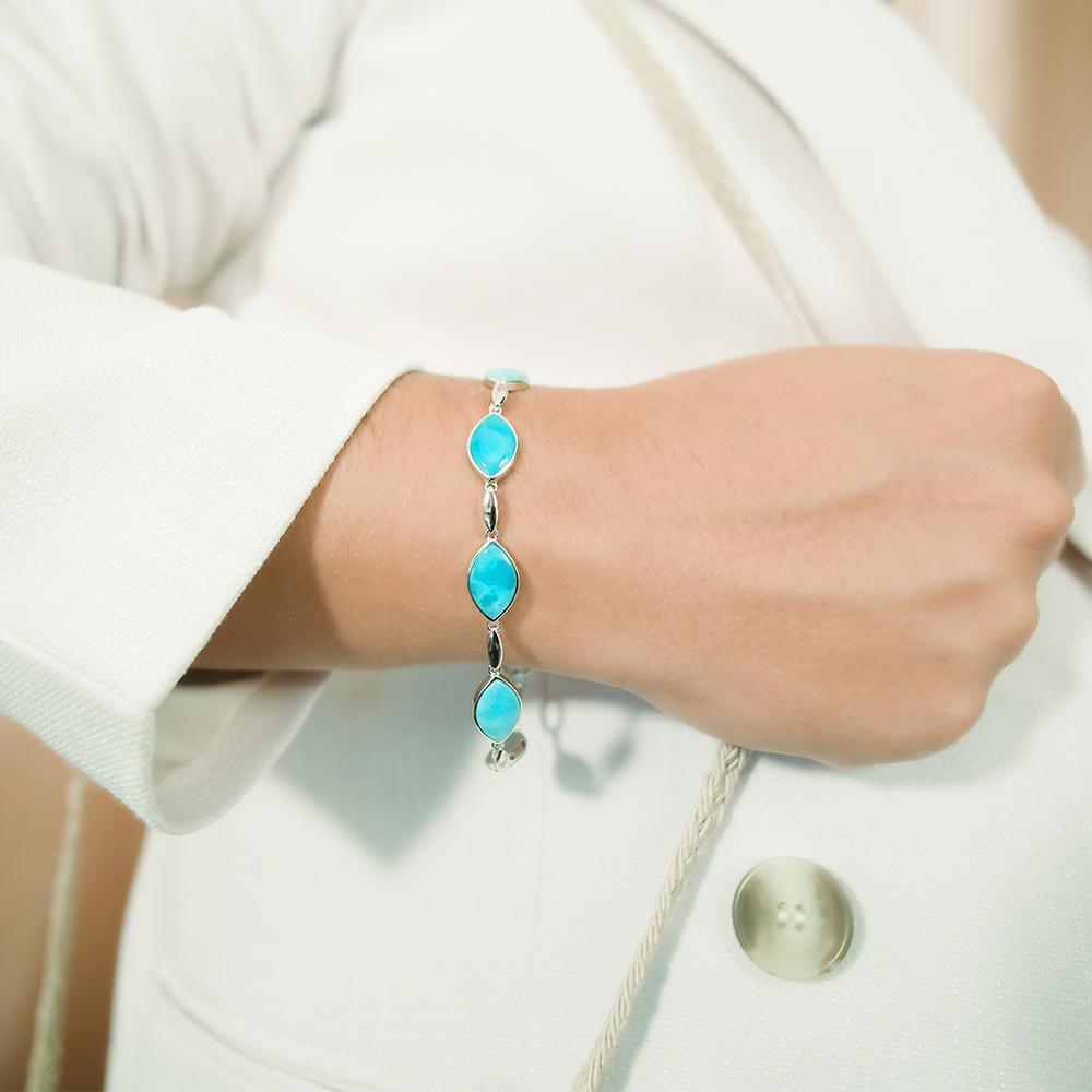 The picture shows a model wearing a 925 sterling silver larimar mandorla bracelet.