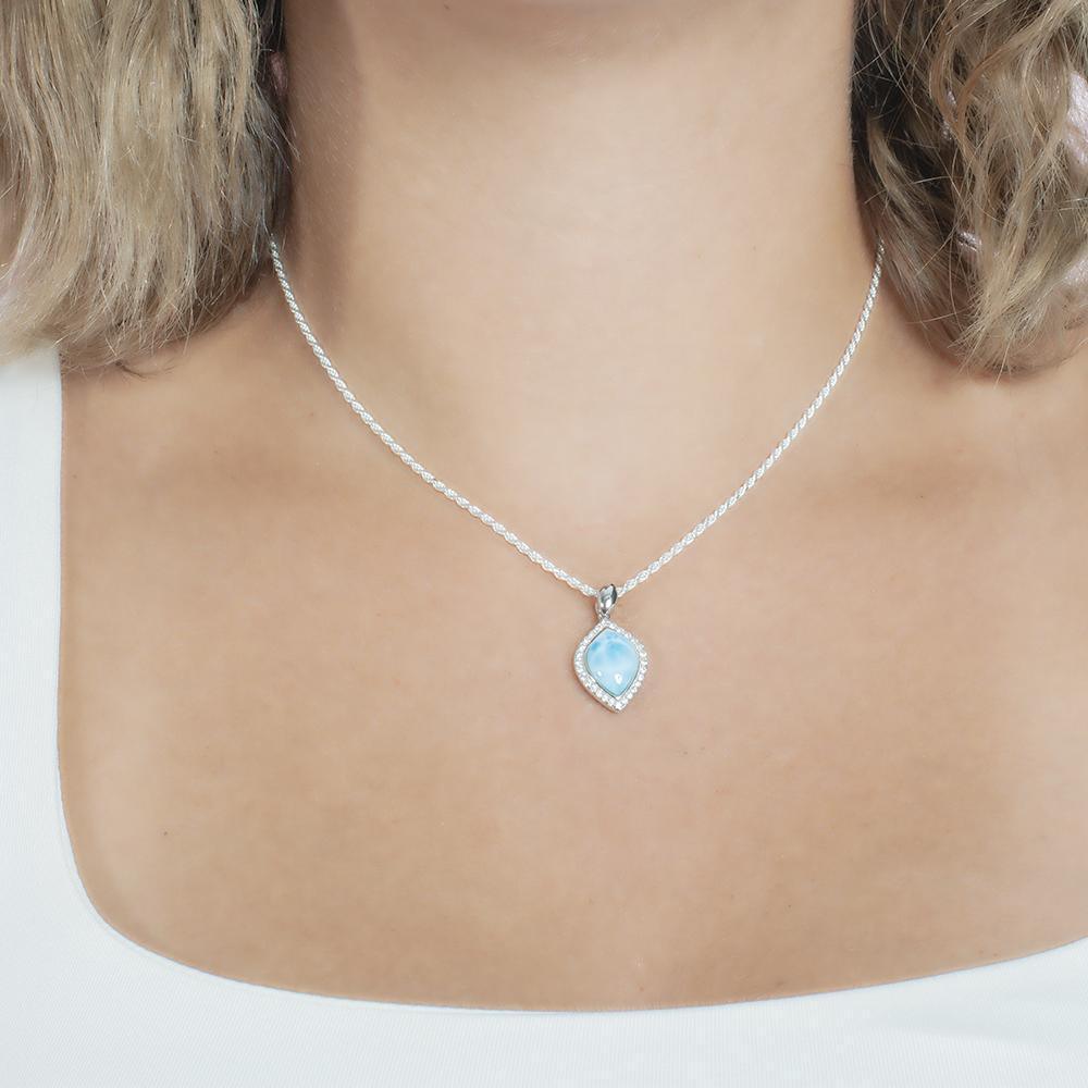 The picture shows a model wearing a 925 sterling silver larimar mandorla pendant with topaz.