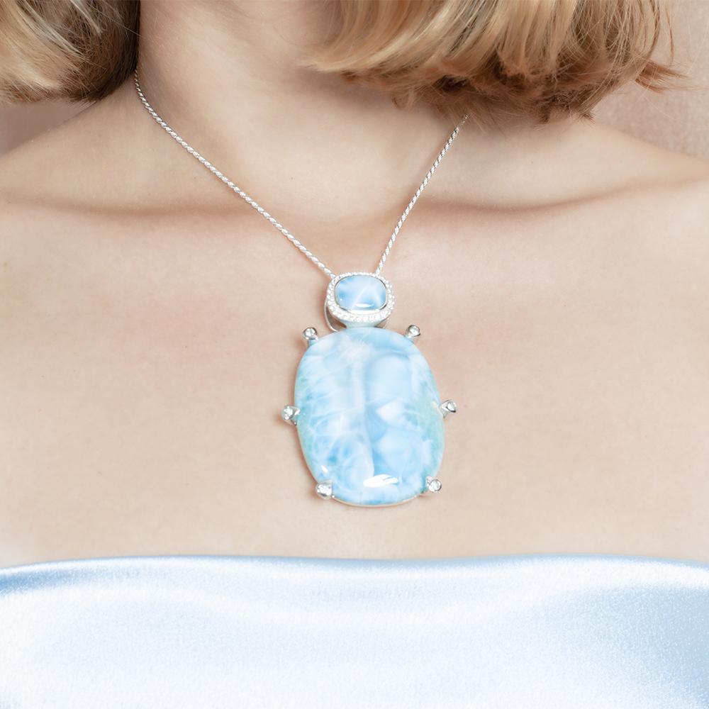The picture shows a model wearing a 925 sterling silver larimar pendant.