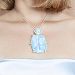 The picture shows a model wearing a 925 sterling silver larimar pendant.