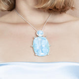The picture shows a model wearing a 925 sterling silver larimar pendant.