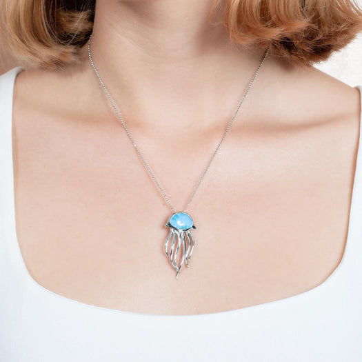 The picture shows a model wearing a 925 sterling silver larimar medusa jellyfish pendant.