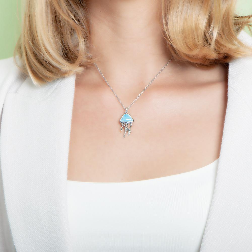 The picture shows a model wearing a 925 sterling silver larimar moon jellyfish pendant.