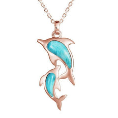 The picture shows a 14K rose gold two dolphin pendant with larimar gemstones.