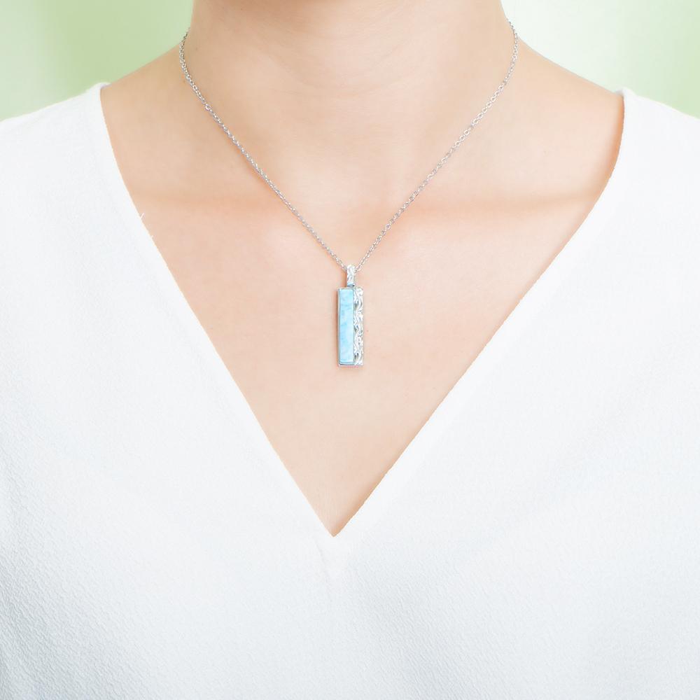 The picture shows a model wearing a 925 sterling silver larimar bar pendant.