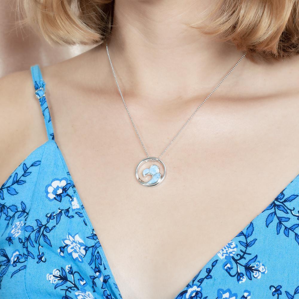 The picture shows a model wearing a 925 sterling silver larimar big wave pendant.