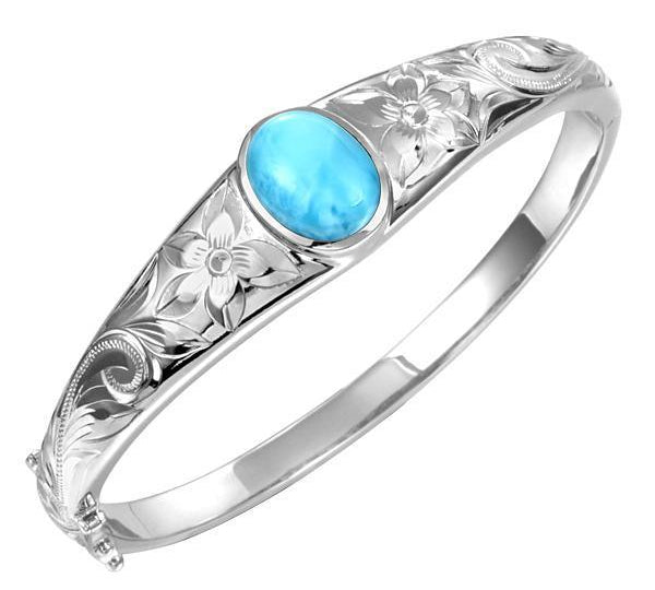 In this photo there is a 925 sterling silver bangle with one blue larimar gemstone and plumeria engravings.