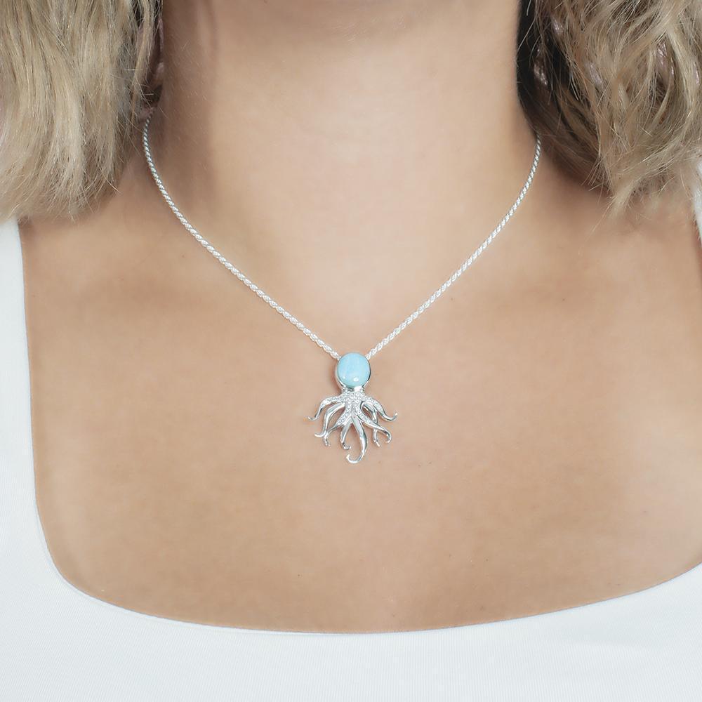 The picture shows a model wearing a 925 sterling silver larimar octopus pendant.
