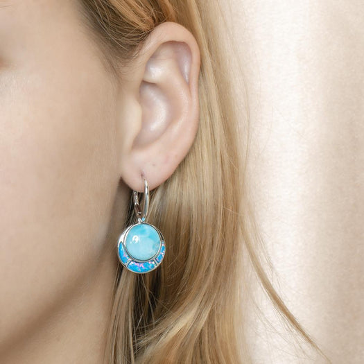 The picture shows a model wearing a 925 sterling silver larimar and opalite circle earring.