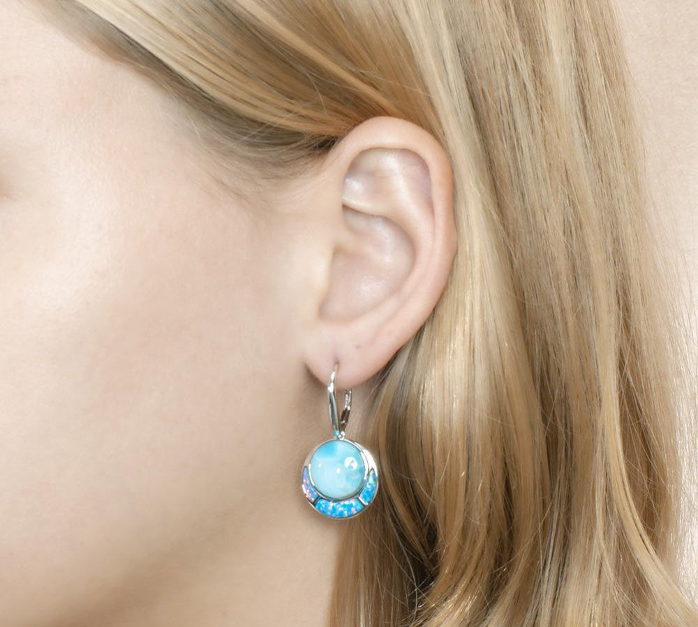 The picture shows a model wearing a 925 sterling silver larimar and opalite circle earring.