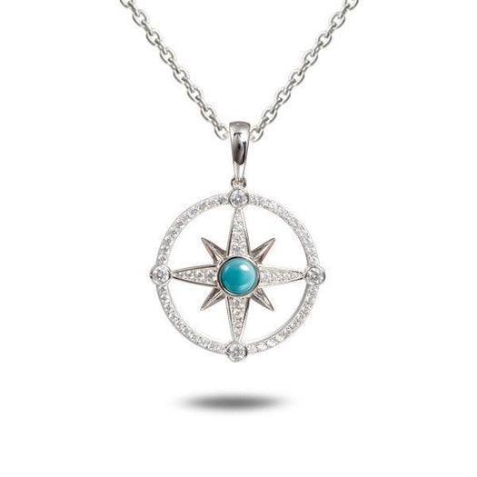 In this photo there is a sterling silver compass pendant with blue larimar and topaz gemstones.