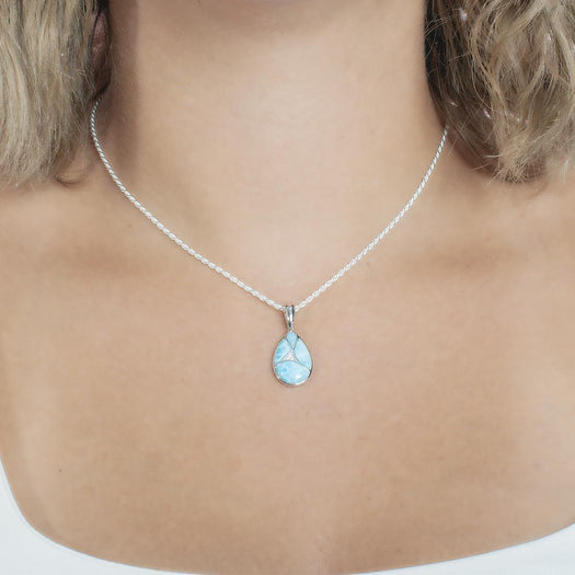 The picture shows a model wearing a 925 sterling silver larimar pieces of love teardrop pendant with cubic zirconia.