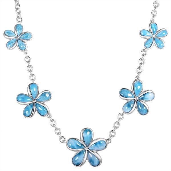 In this photo there is a sterling silver plumeria charm necklace with blue larimar gemstones.
