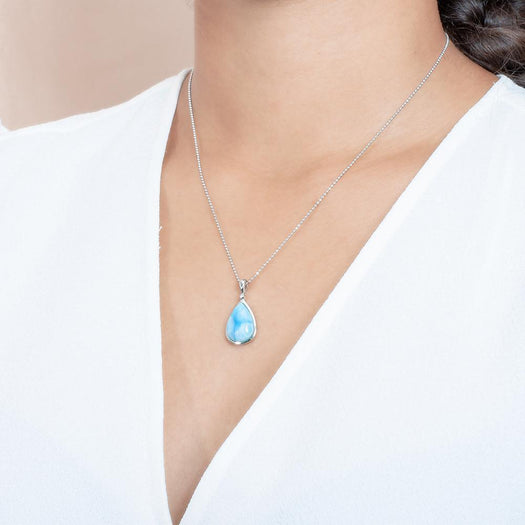The picture shows a model wearing a 925 sterling silver larimar reuleaux teardrop pendant cubic zirconia.