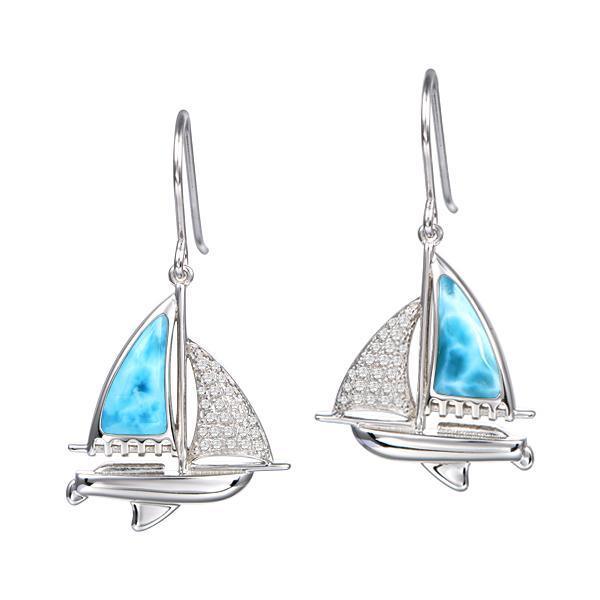 In this photo is a pair of 925 sterling silver sailboat hook earrings with blue larimar and topaz gemstones.