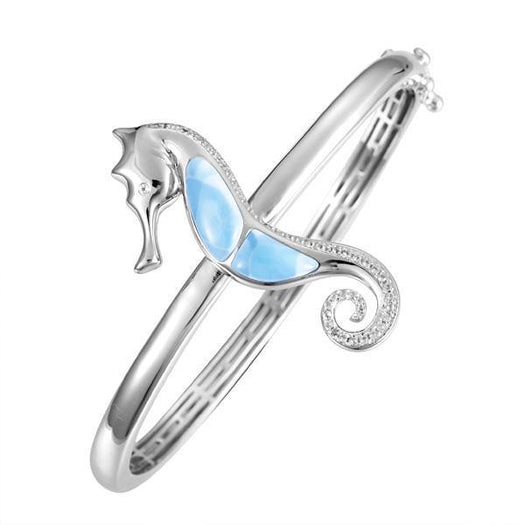 The picture shows a 925 sterling silver larimar seahorse bangle with topaz.