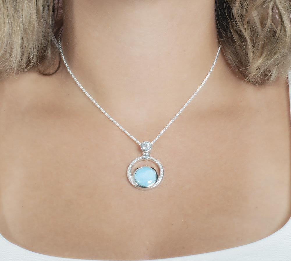 The picture shows a model wearing a 925 sterling silver larimar solar pendant.