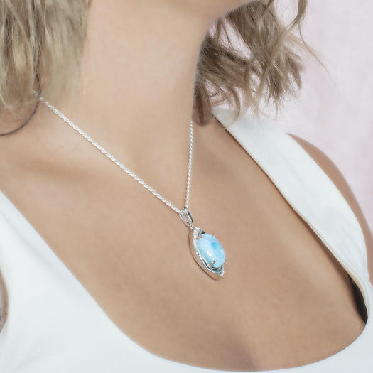 The picture shows a model wearing a 925 sterling silver larimar sparkling eye pendant.