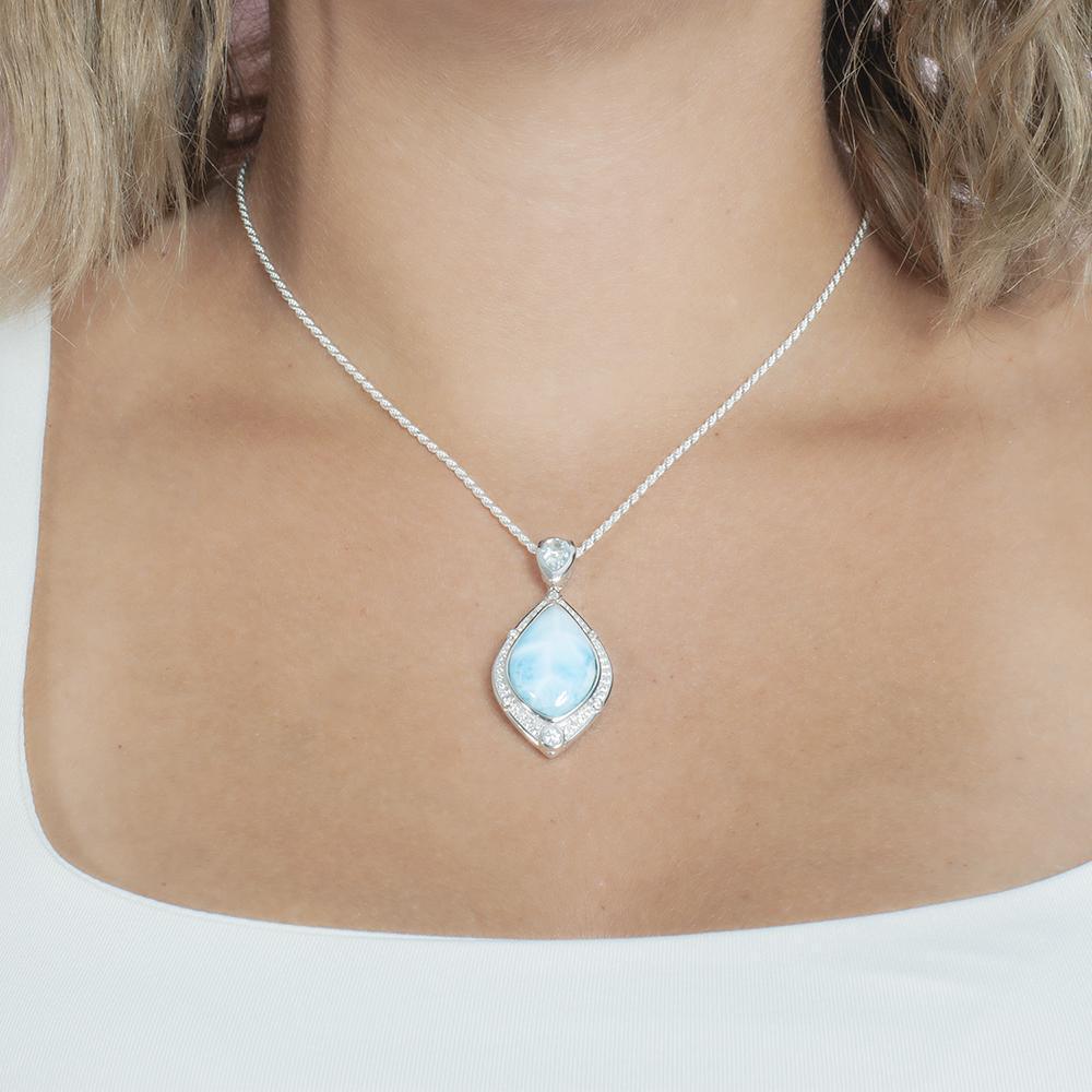 The picture shows a model wearing a 925 sterling silver larimar stars slign mandorla pendant.