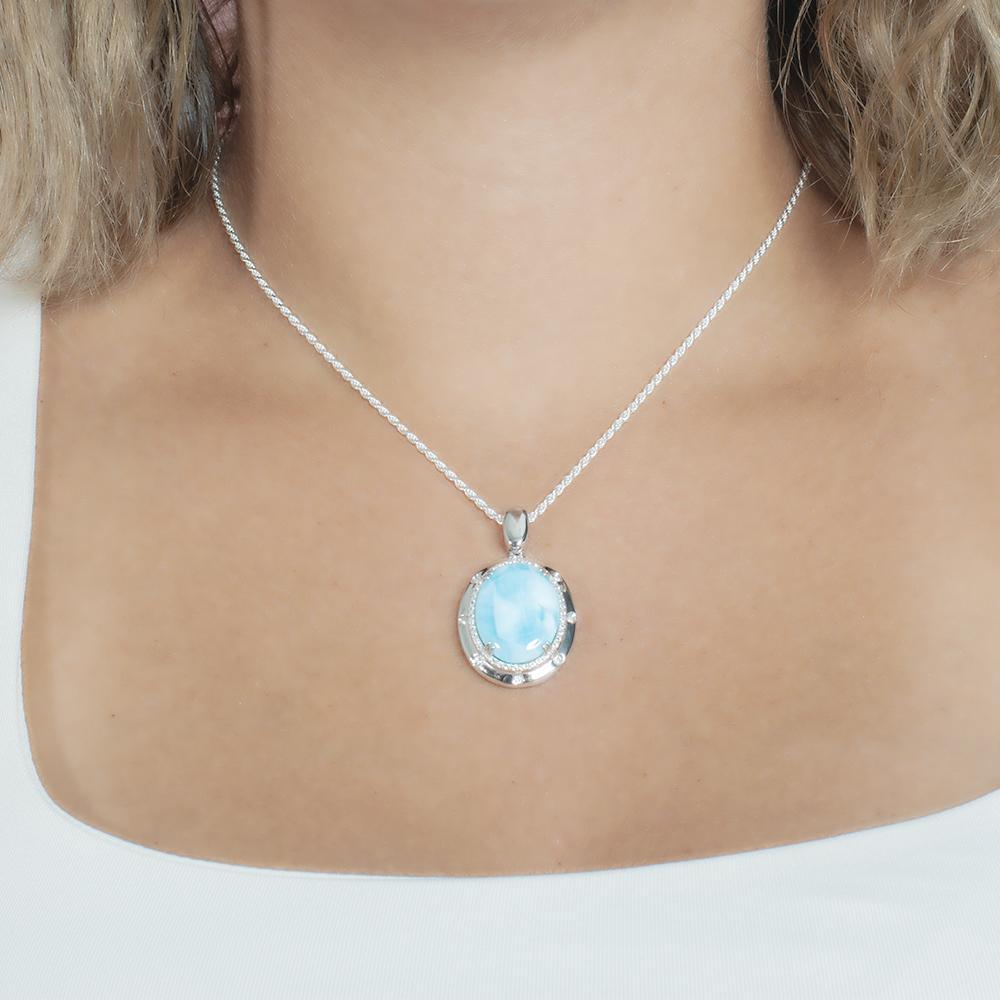 The picture shows a model wearing a 925 sterling silver larimar stars align pendant.