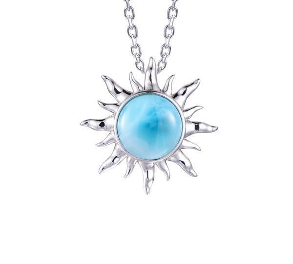 In this picture there is a sun pendant with a blue larimar gemstone set in sterling silver.