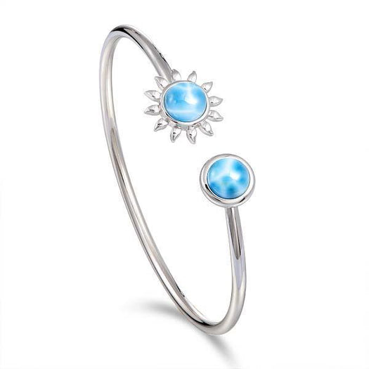 In this photo there is a 925 sterling silver sunflower and circle bangle with two blue larimar gemstones.