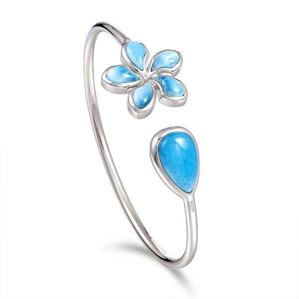 In this photo there is a sterling silver plumeria and teardrop pendant with blue larimar gemstones.