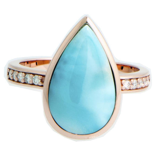 This picture shows a 14K rose gold larimar teardrop ring with a diamond band.