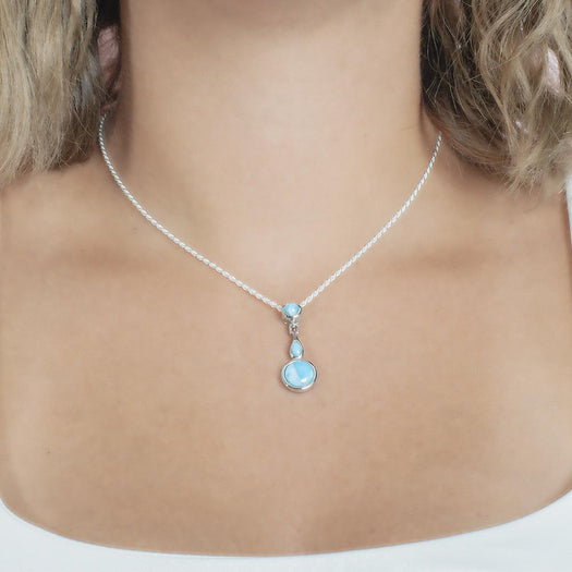 The picture shows a model wearing a 925 sterling silver larimar pendant featuring two circles and a teardrop in the center.