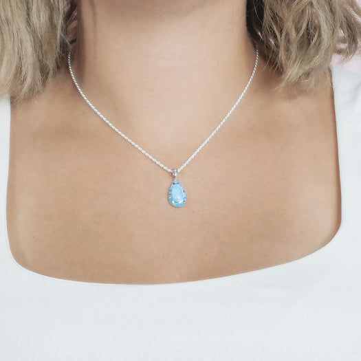 The picture shows a model wearing a 925 sterling silver larimar teardrop pendant.