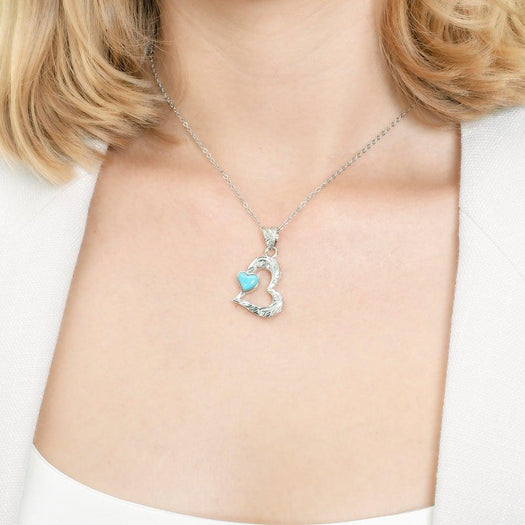 The photo shows a sterling silver larimar pendant featuring a heart shape. 