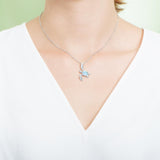 The picture shows a model wearing a 925 sterling silver larimar sea turtle pendant.